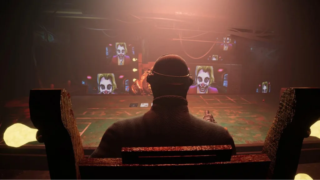 Gracz siedzący przy stole do blackjacka w mrocznym pomieszczeniu, otoczony ekranami z przerażającą twarzą klauna w grze Blackjack Roulette.
